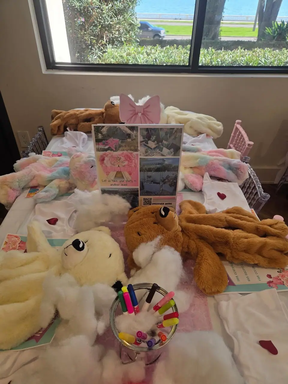 Plush bears and supplies laid out for a build-a-bear party