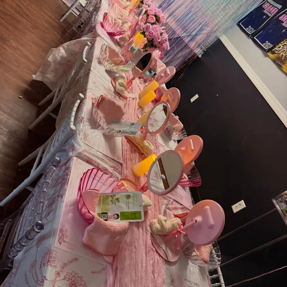 Spa party table set with pink mirrors, headbands and roses
