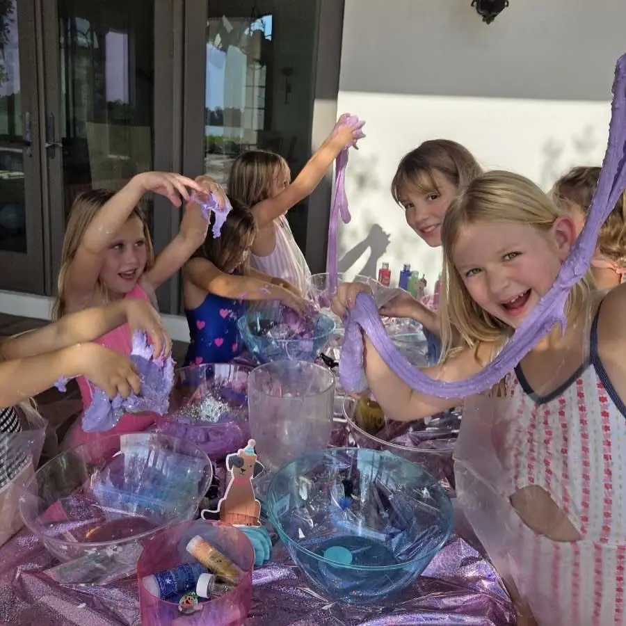 Kids stretching slime at a Slumberr slime party