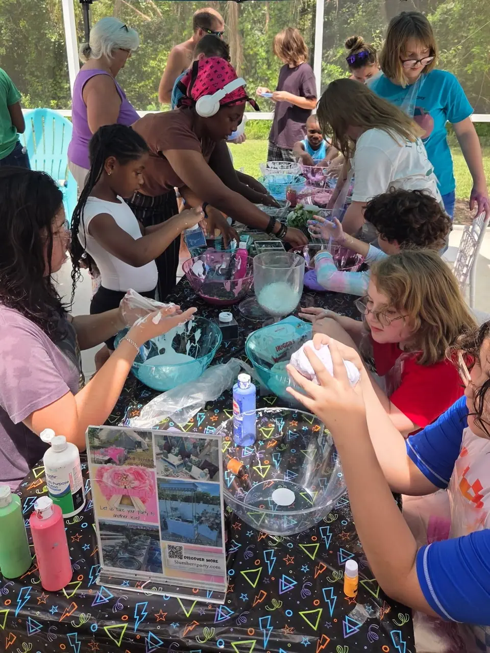 Kids mixing slime at a Slumberr slime party