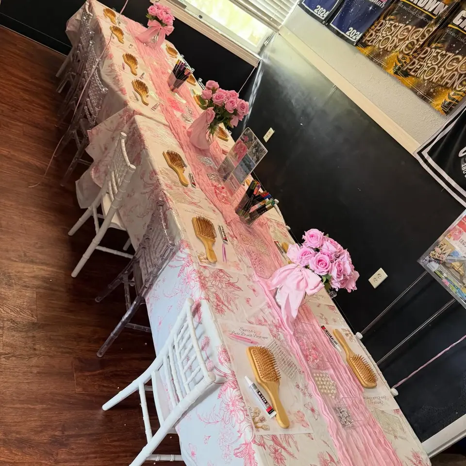 Hair brush decorating party table set with brushes, pearls, markers and pink roses