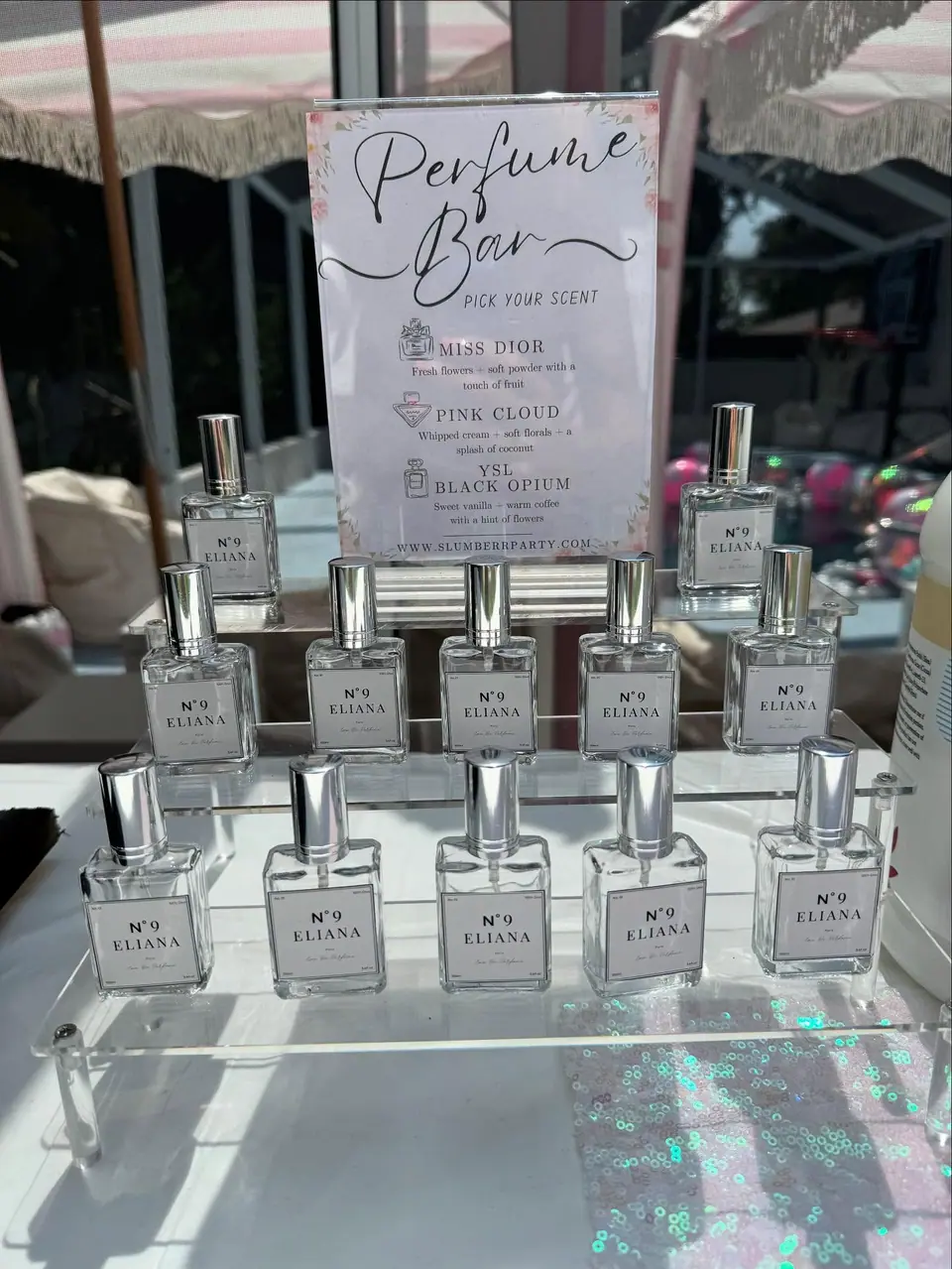 Perfume bar table with personalized bottles and a pick-your-scent sign