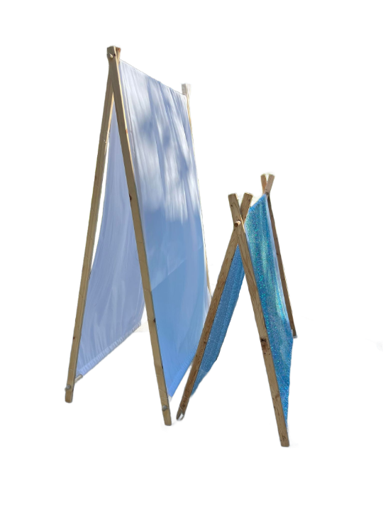 Two cloth sheets are hung between wooden frames, one significantly larger than the other, both angled to form an A-frame structure, perfect for a kids party rental.