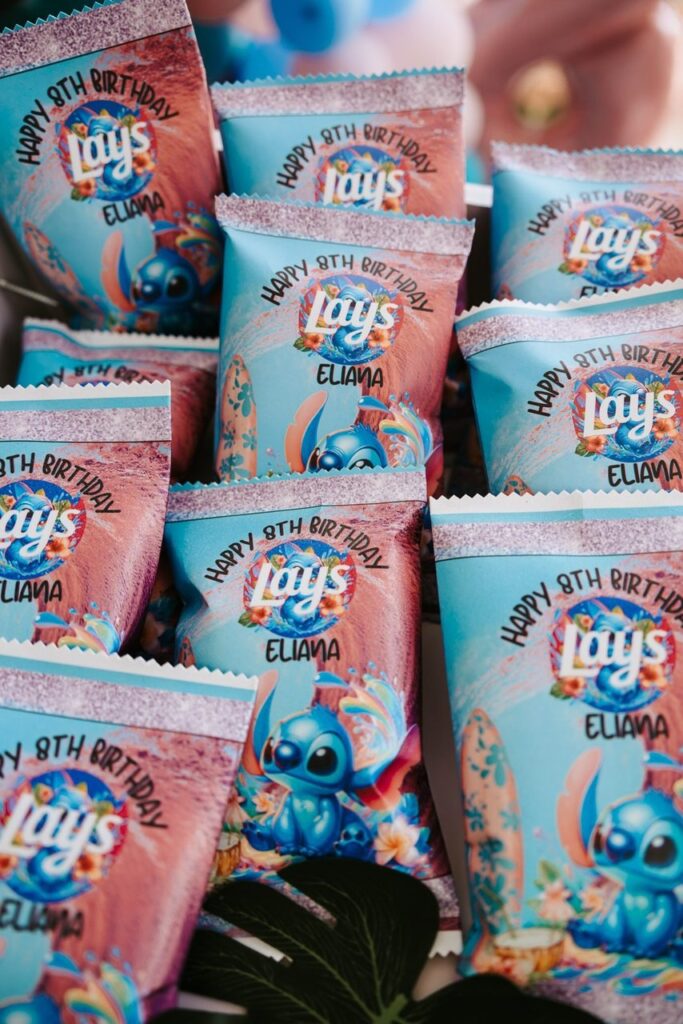 Several Lay's chip bags with custom "Happy 8th Birthday Eliana" labels featuring a cartoon character and colorful design arranged closely together.